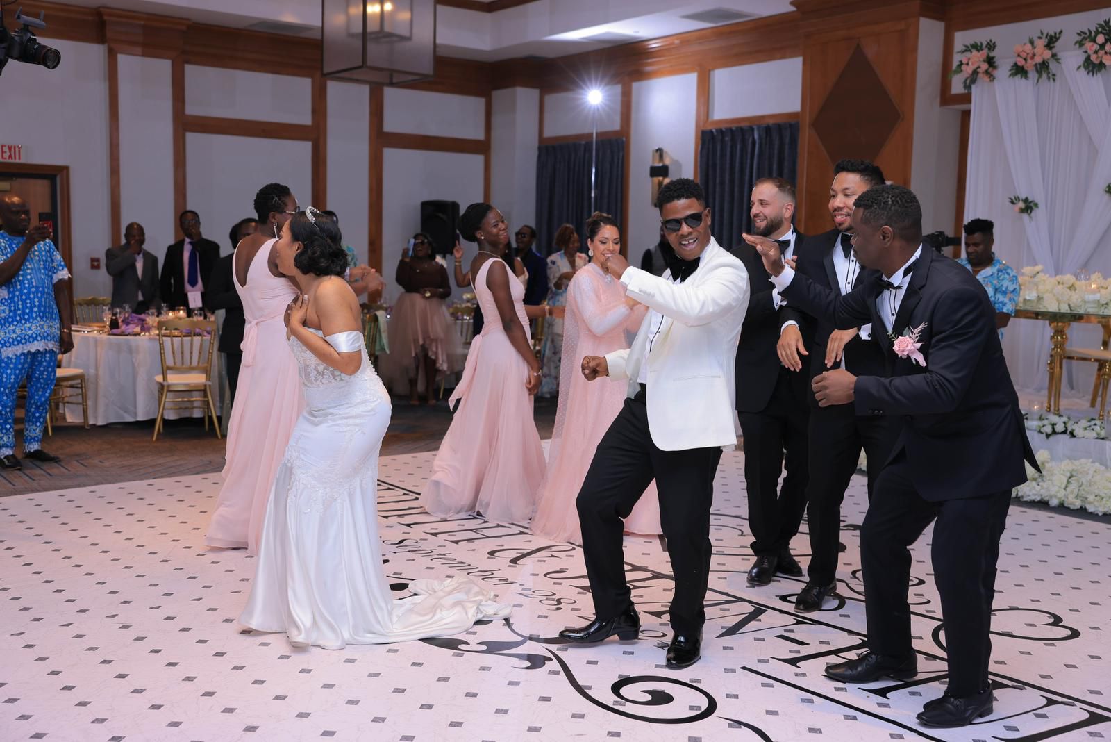Wedding party dancing with the couple on the reception floor