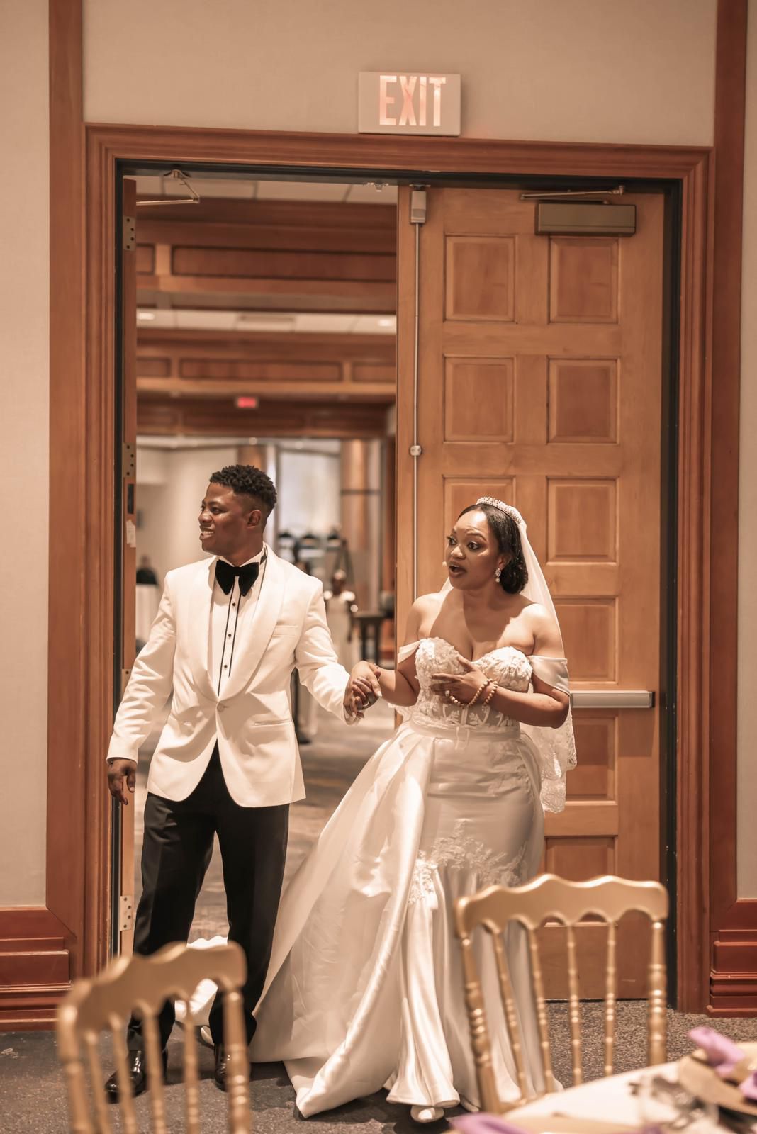 Newlyweds entering the reception hall hand in hand