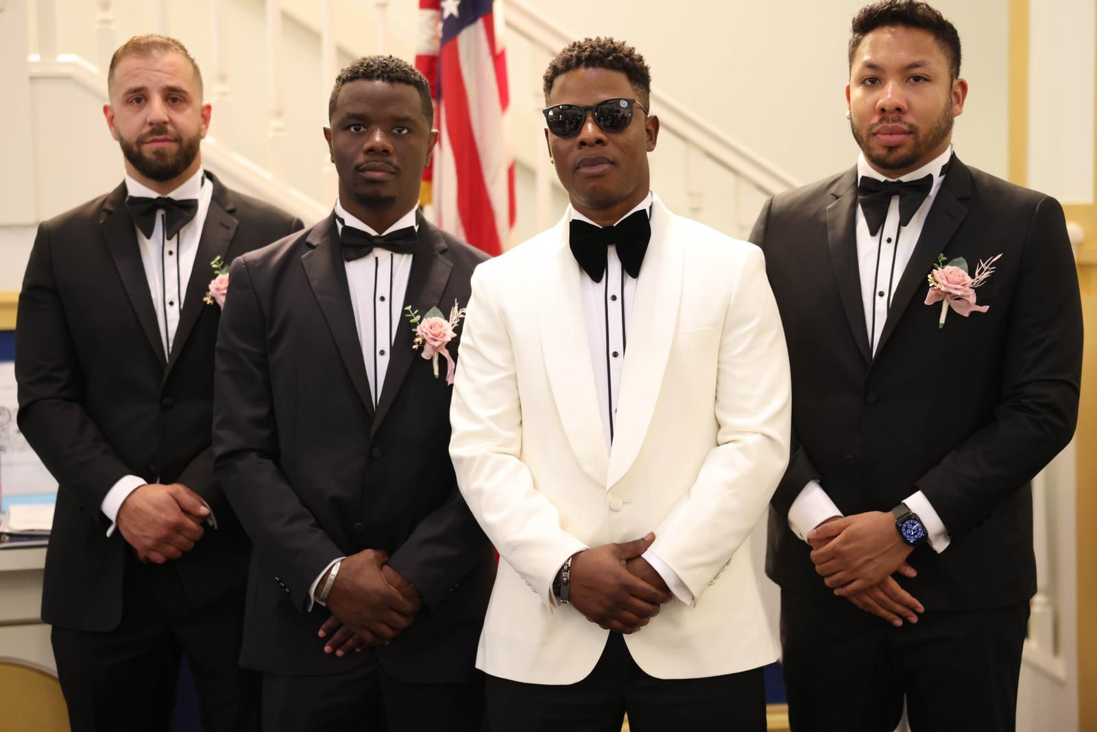 Groom in an ivory tuxedo with his groomsmen