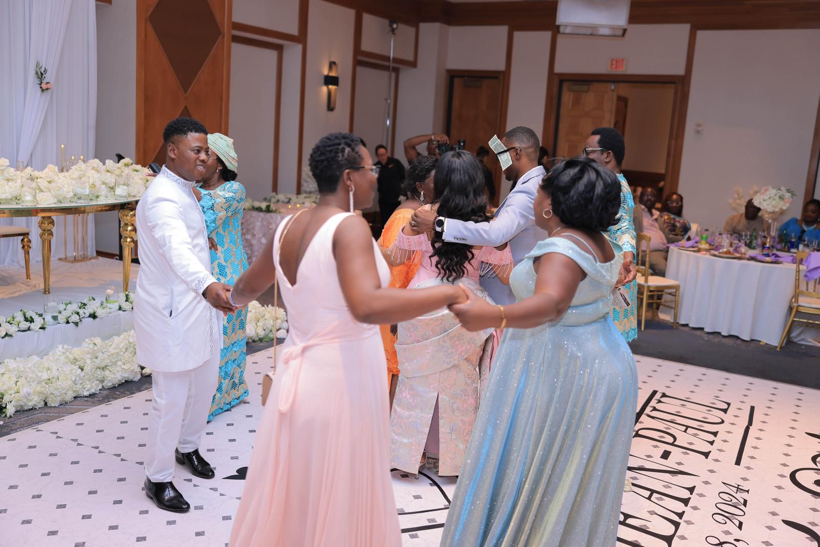 Guests dancing in a circle at the reception